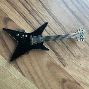 Black guitar belt buckle.